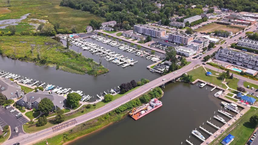 Aerial crane shot of New Buffalo Municipal Marina, Michigan, with stunning views over Lake Michigan and the peaceful shoreline on a sunny summer day