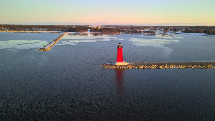 Aerial view of Manistique East Breakwater Lighthouse during sunrise in Lake Michigan.