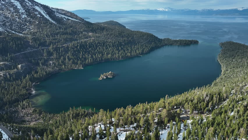 Panoramic drone shot around the wintry Emerald bay, spring day at Lake Tahoe, USA