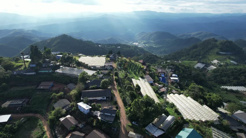 Aerial view from drone of the rural village and agriculture fields in the mountains