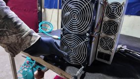 Close-up of a professional wearing black gloves troubleshooting and securing a high-performance cooling unit in a specialized mining server. - Powered by Shutterstock - Get 15% off with code: PIKWIZARD15