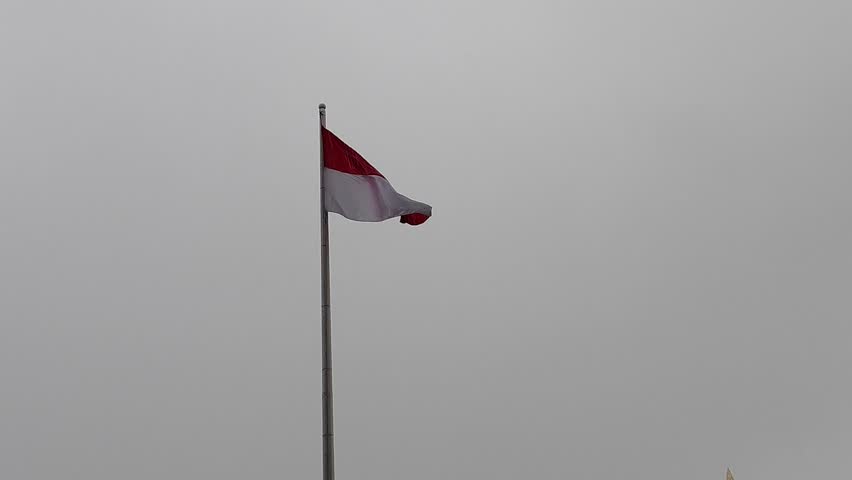
The red and white flag flutters when it rains and blows
