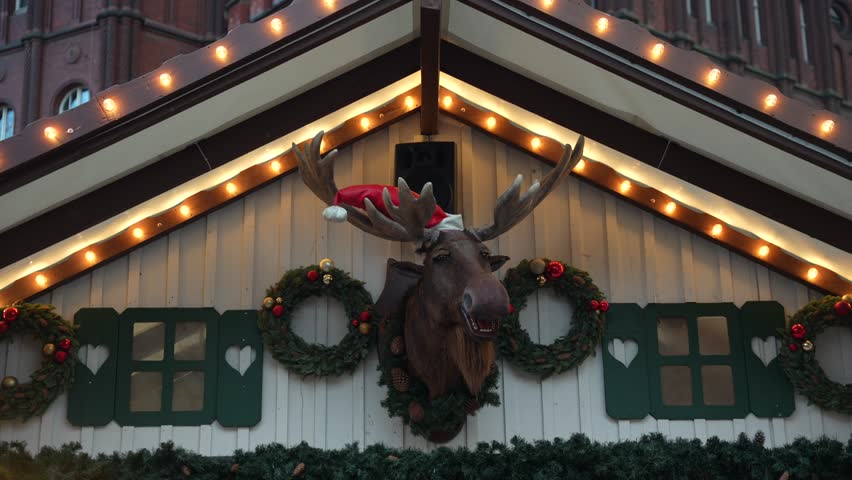 Gdansk Christmas market stall with talking moose head. Polish winter festivities
