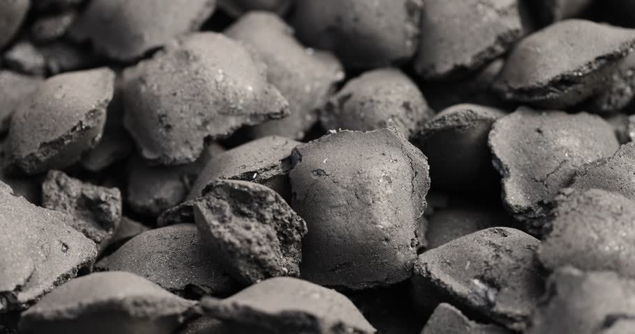 charcoal compressed from crumbs is obtained under pressure and used to light a fire and cook food on the grill, black charcoal in briquettes for barbecues and grills