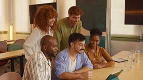 Young multicultural business team discussing a project on a digital tablet. Group of creative professionals working together in a conference room - Powered by Shutterstock - Get 15% off with code: PIKWIZARD15