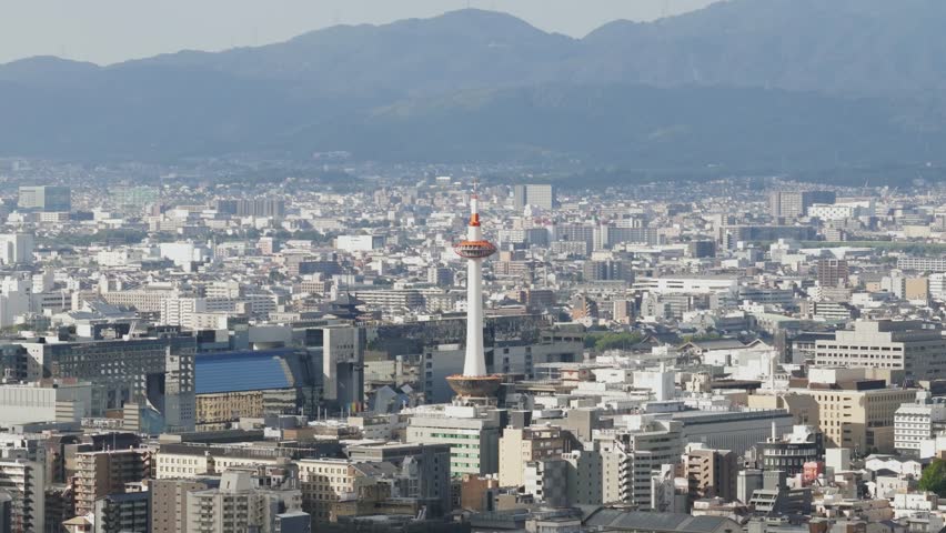 Aerial establishing of Japan Kyoto city with Iconic Tower, temples and buildings urban cityscape