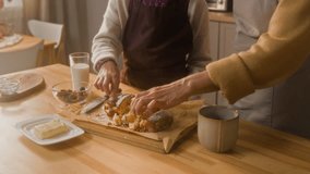 Tilt up shot of happy pre-teen girl and senior grandmother eating freshly baked loaf cake and high fiving at home kitchen - Powered by Shutterstock - Get 15% off with code: PIKWIZARD15