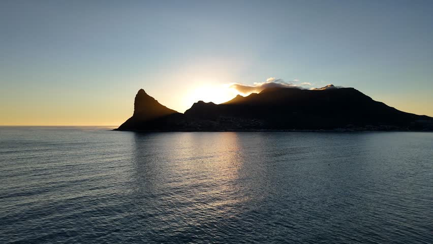 Aerial view of sun appearing over The Sentinel, Hout Bay, Cape Town, South Africa