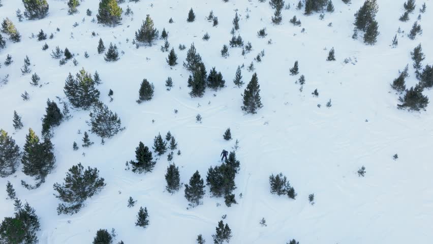 A snowboarder skiing off-piste filmed with a drone in Grandvalira Andorra