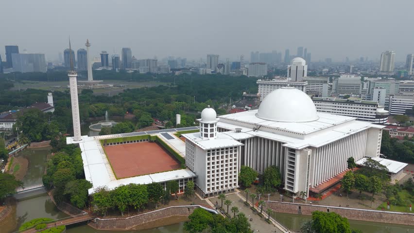 Aerial View Of Istiqlal Mosque In Jakarta Indonesia, With Cityscape In Horizon