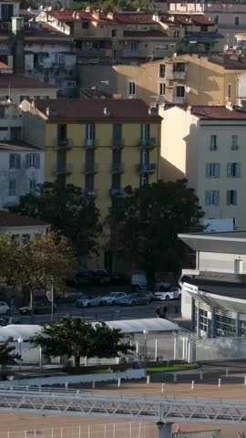 Scenic coastline of Corsica island seen from cruise ship with green hills rocky cliffs turquoise sea and coastal towns in sunlight Mediterranean travel destination natural landscape and summer view