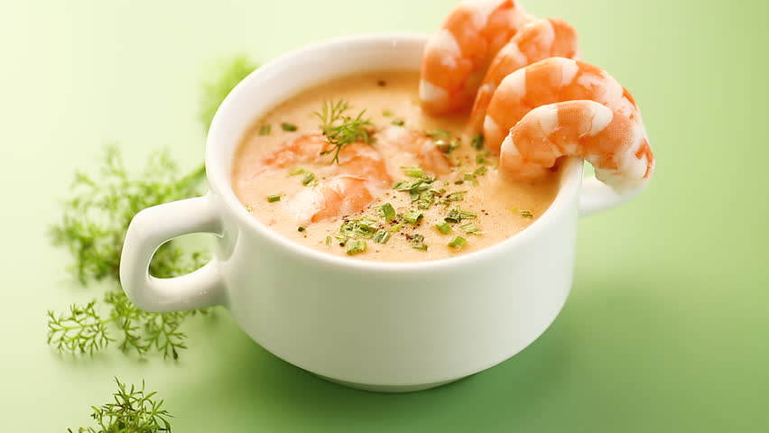 Fresh seafood soup highlighting vibrant shrimp and smooth creamy broth