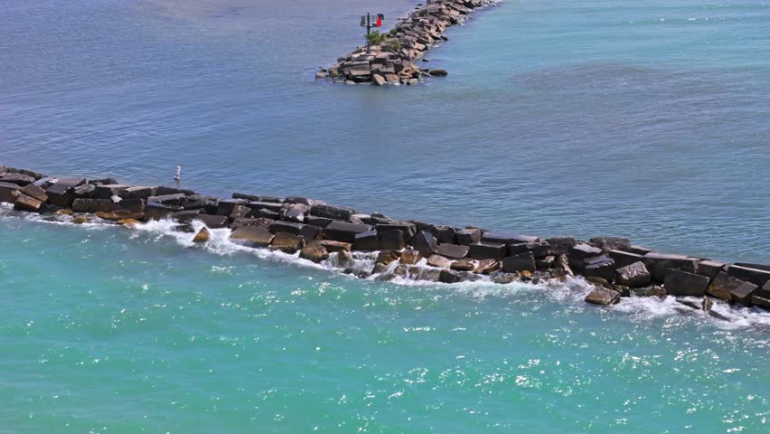Telephoto aerial truck shot of New Buffalo Beach, Michigan, with stunning views over Lake Michigan and the peaceful shoreline on a sunny summer day