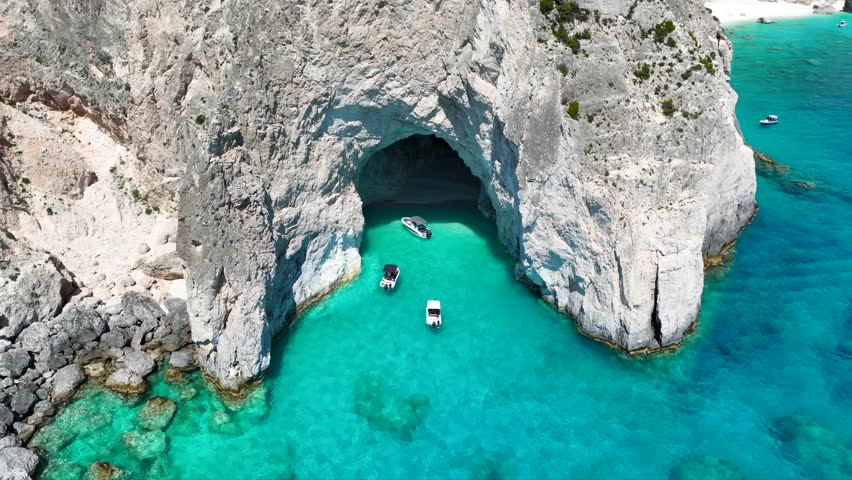 Aerial drone cinematic video of scenic cave of Eros visited by boats and yachts in northern part of Myzithres islets a true paradise in island of Zakynthos, Ionian, Greece