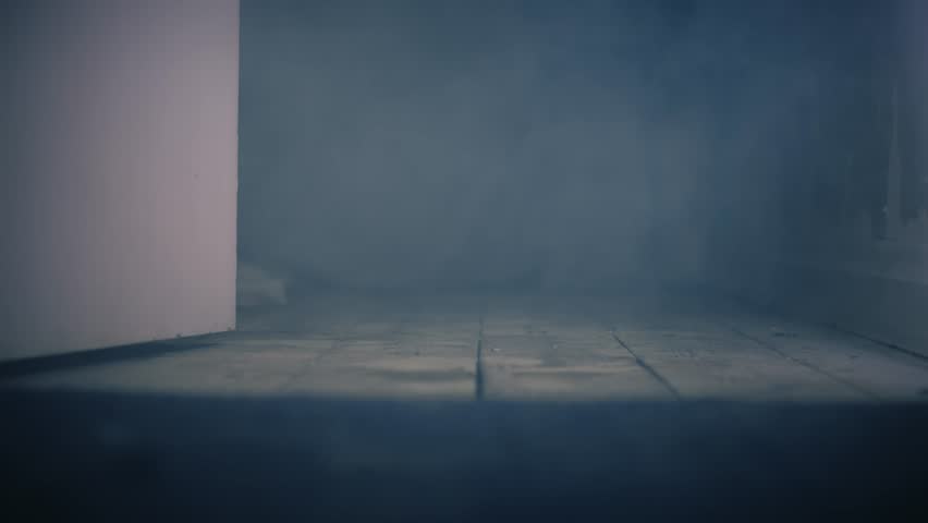Room full of smoke with open door medium 4k slow motion shot selective focus