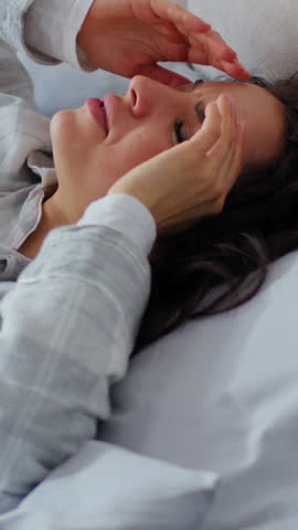 Close up ill unhealthy Caucasian sick woman feeling headache pain head painful migraine discomfort waking up in bed bedroom home female girl hangover massaging temples ache medicine health problem