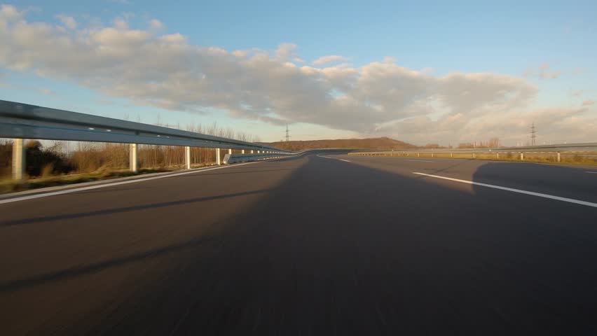 driving a Race Car on a racetrack on a sunny day. POV view