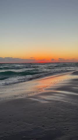 Gulf of Mexico Destin, Florida sunset with colorful reflections onto the sand