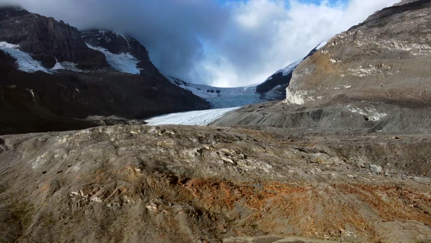 Athabasca glacier, located in the columbia icefield of jasper national park, reveals a stark landscape of rock and ice, highlighting the effects of climate change on glacial retreat