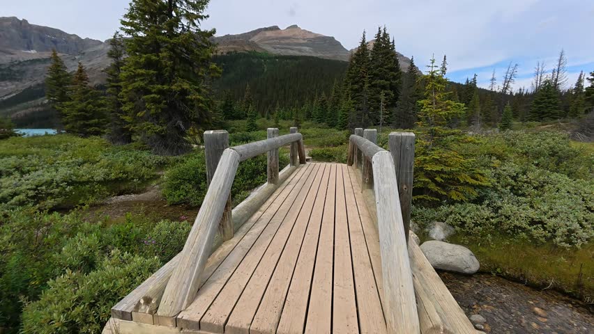 Picturesque views of bow lake and surrounding mountains in banff national park, alberta, showcasing wooden walkways, lush greenery, and the iconic turquoise water