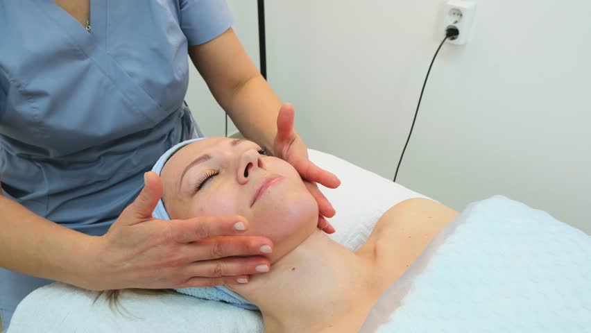 Woman getting face massage at spa