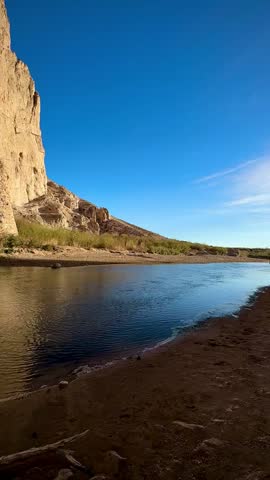 Rocky Shores of Boquillas Canyon with Rio Grande and Sunlit Cliffs (Big Bend National Park, Texas, USA)