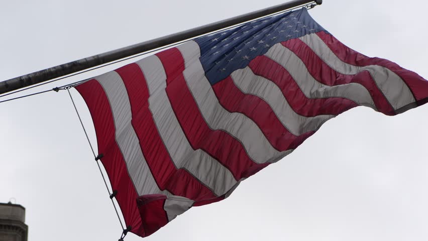 American Flag On Stone Facade, Autumn Leaves, Angled Flagpole, Gentle Wind, Historical Church Backdrop, Evokes Heritage Parade, Neighborhood
