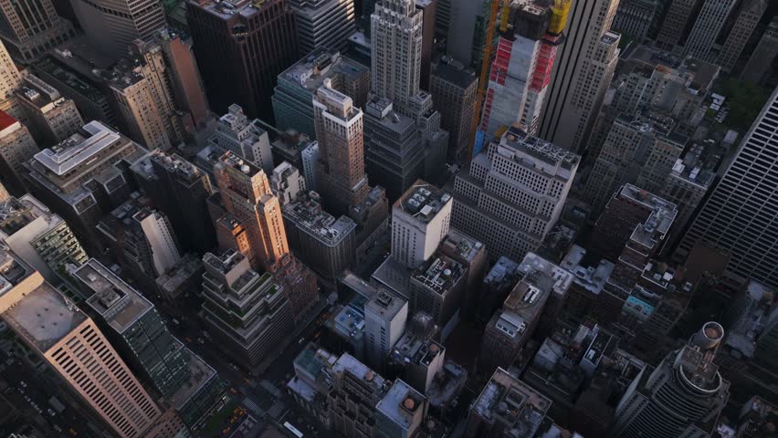 Aerial view overlooking a high-rise construction site, sunset in Midtown, New York 4k