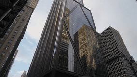 Golden Glass Tower Reflecting Surrounding Buildings In Sharp Angular Geometry, LowAngle Perspective Captures Mirrored Facades, Corner - Powered by Shutterstock - Get 15% off with code: PIKWIZARD15