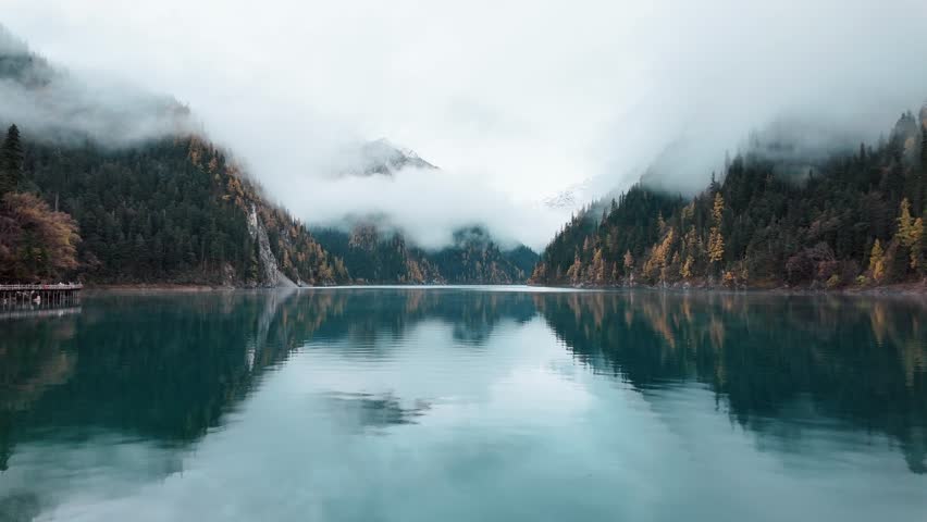 Scenery Jiuzhaigou national park in Sichuan, China. Beautiful Long lake and snow mountain in Autumn season. Famous Landmark and Vacation near Chengdu, China. Asia travel concept