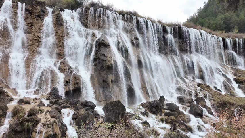 Scenery Jiuzhaigou national park in Sichuan, China. Beautiful of Nuorilang Waterfall in Autumn season. Famous Landmark and Vacation near Chengdu, China. Asia travel concept 