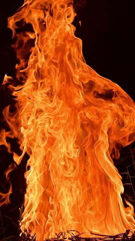 Abstract fire flame forming the silhouette of a dancing woman, glowing in warm orange and yellow tones against a dark background