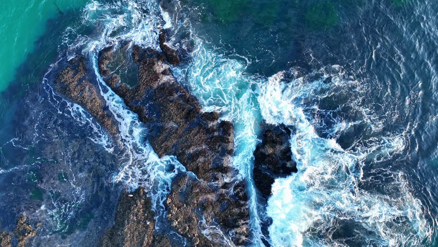 Crashing waves aerial. Ocean waves from top. Dramatic waves on reef. Aerial view of ocean waves.