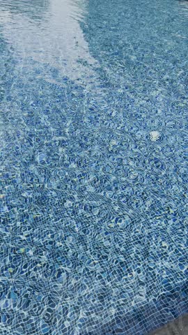 Swimming pool with blue crystal clear water surface and ripple wave background