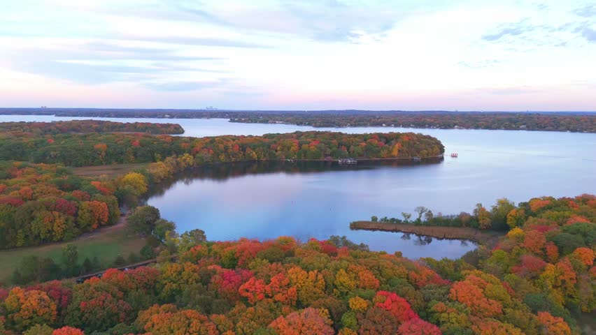 Autumn spreads across the shores of Lake Minnetonka, with aerial views revealing a mosaic of trees and water.