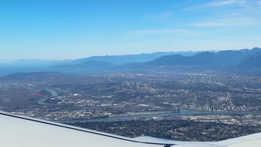 Airplane window POV shot of Greater Vancouver, British Columbia, Canada. 4K