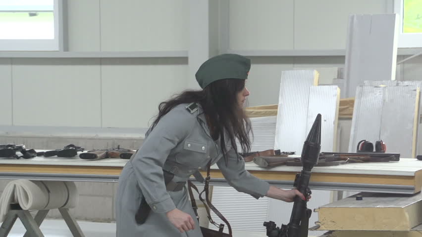 Female officer aiming with anti tank gun RPG7 in slow motion