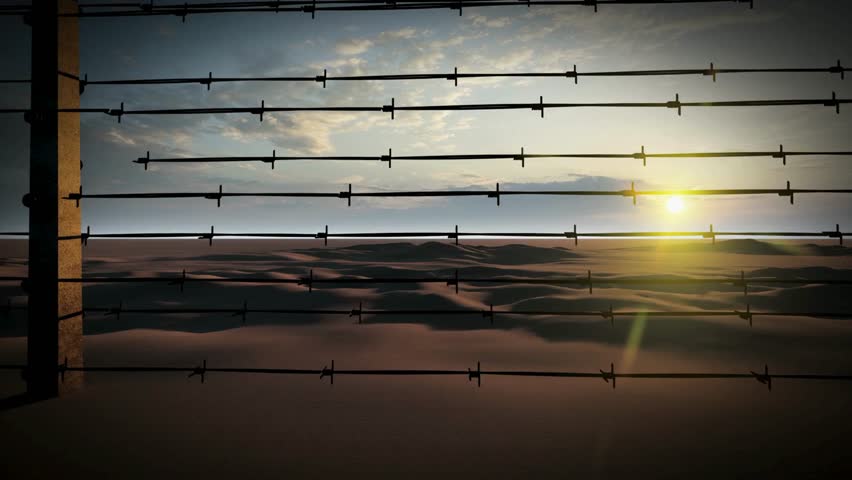 Close-up of a barbed wire fence. CU, PAN, Barbed wire fence surrounding prison, guard tower in background, Singapore Illegal immigration concept