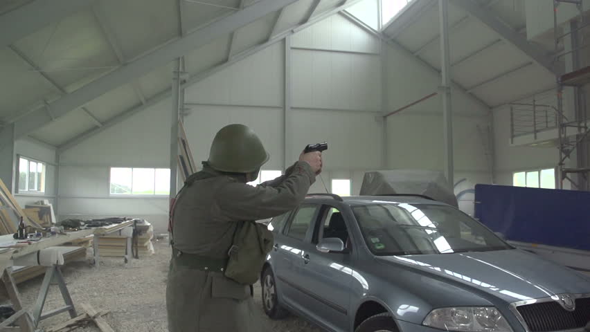 Soldier firing gun in warehouse