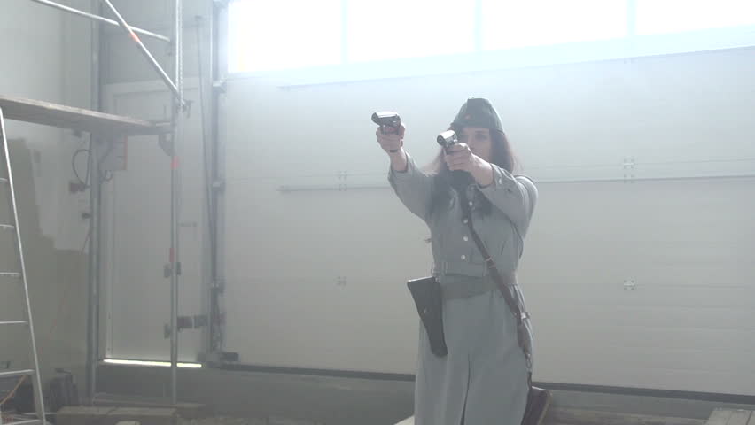 Female officer shooting 2 pistols in slow motion