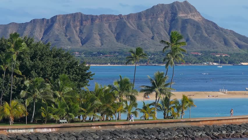 Beautiful aerial view of the Diamond head crater near Honolulu, Hawaii. Magical Waikiki beach in Hawaii with palm trees and Pacific ocean waves.
