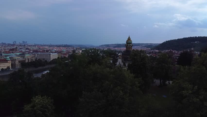 Aerial dusk view of Prague skyline with Vltava River and multiple bridges