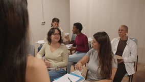 Over the shoulder view of a group of attentive and diverse female students actively participating and interacting during a lecture in a classroom - Powered by Shutterstock - Get 15% off with code: PIKWIZARD15