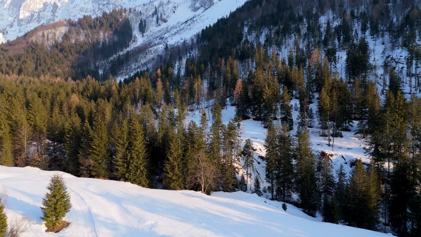 Aerial drone view of a snowy valley and mountain peaks in Val di Scalve, Orobie Alps. Breathtaking Italian winter landscape covered in fresh snow