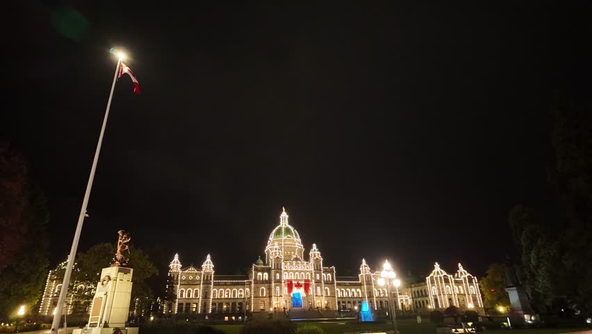 Gimbal wide booming down shot of the historic Parliament Buildings on a rainy night in Victoria, British Columbia, Canada. 4K