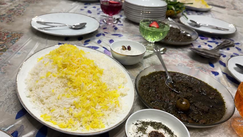 Persian dining table to serve ghorme sabzi national persian dish steamed rice tahdig traditional cuisine family gathering Iran lifestyle holiday happy parents children eating love Ramadan dinner lunch