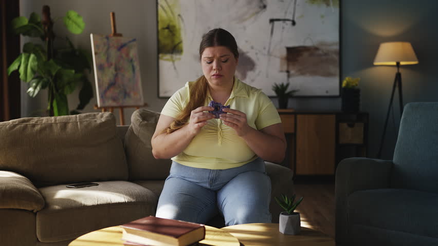 Lonely curvy woman eating high calorie dessert, compulsive eating disorder