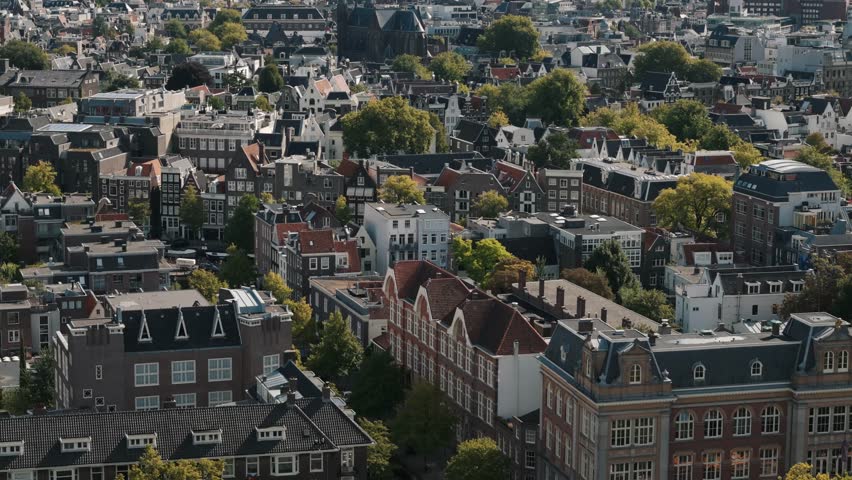 Approaching Amsterdam’s rooftops with a towering church in the distance