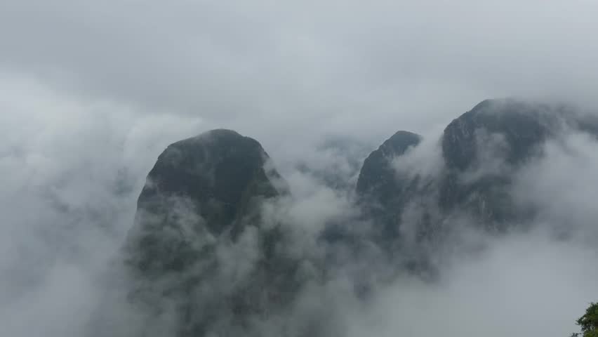 Machu Picchu Ruins Emerging from Clouds
