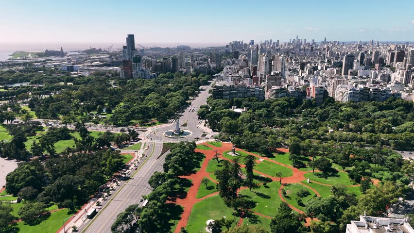 Aerial view of Buenos Aires showing Plaza Italia and the green areas of Palermo, with wide avenues, urban parks, monuments and dense city skyline in the background, capturing the contrast between nature and modern architecture in Argentina’s capital city on a clear sunny day.